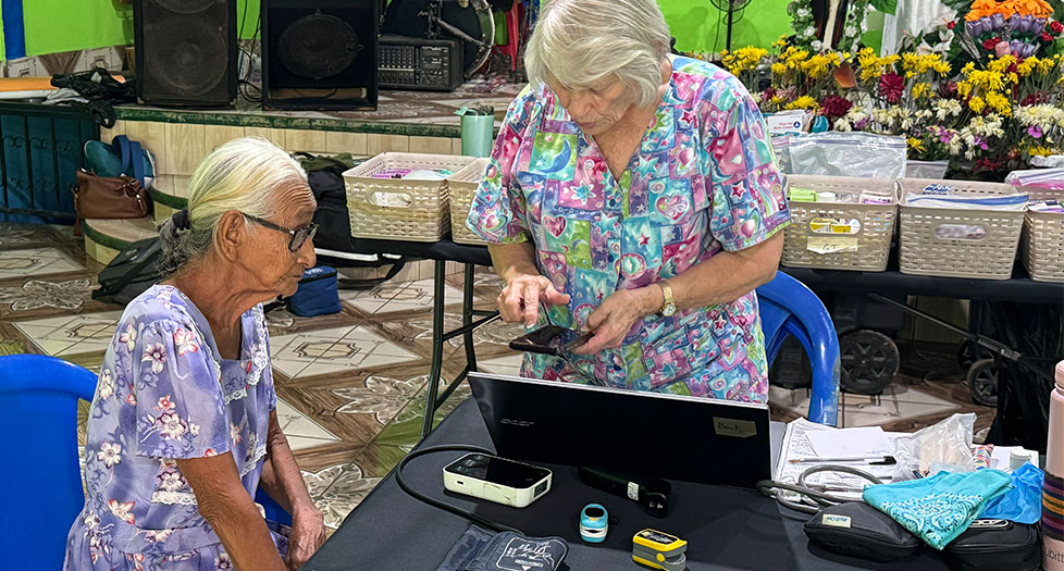 Becky, RN, caring for a patient at a GSG Missions village medical clinic in Guatemala.